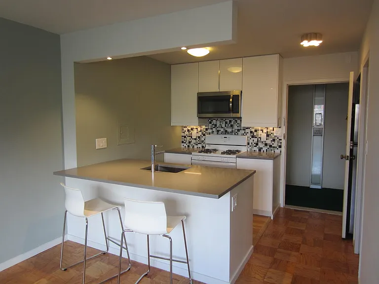 Open kitchen with bar counter & stools