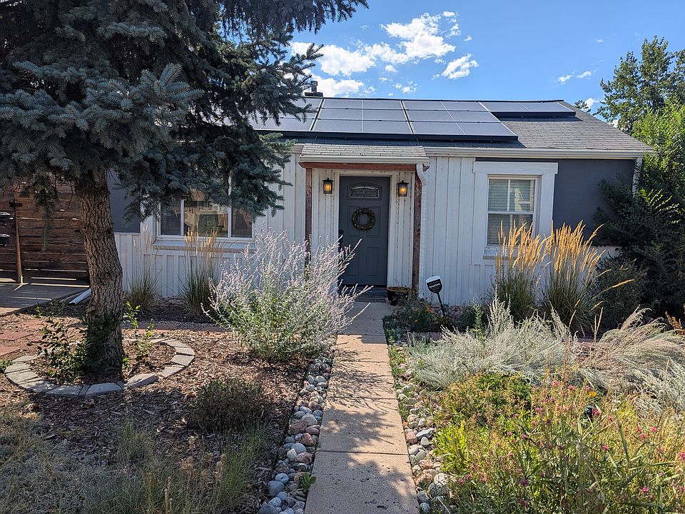 Front of home - rooftop solar panels, native pollinator xeroscaping front yard