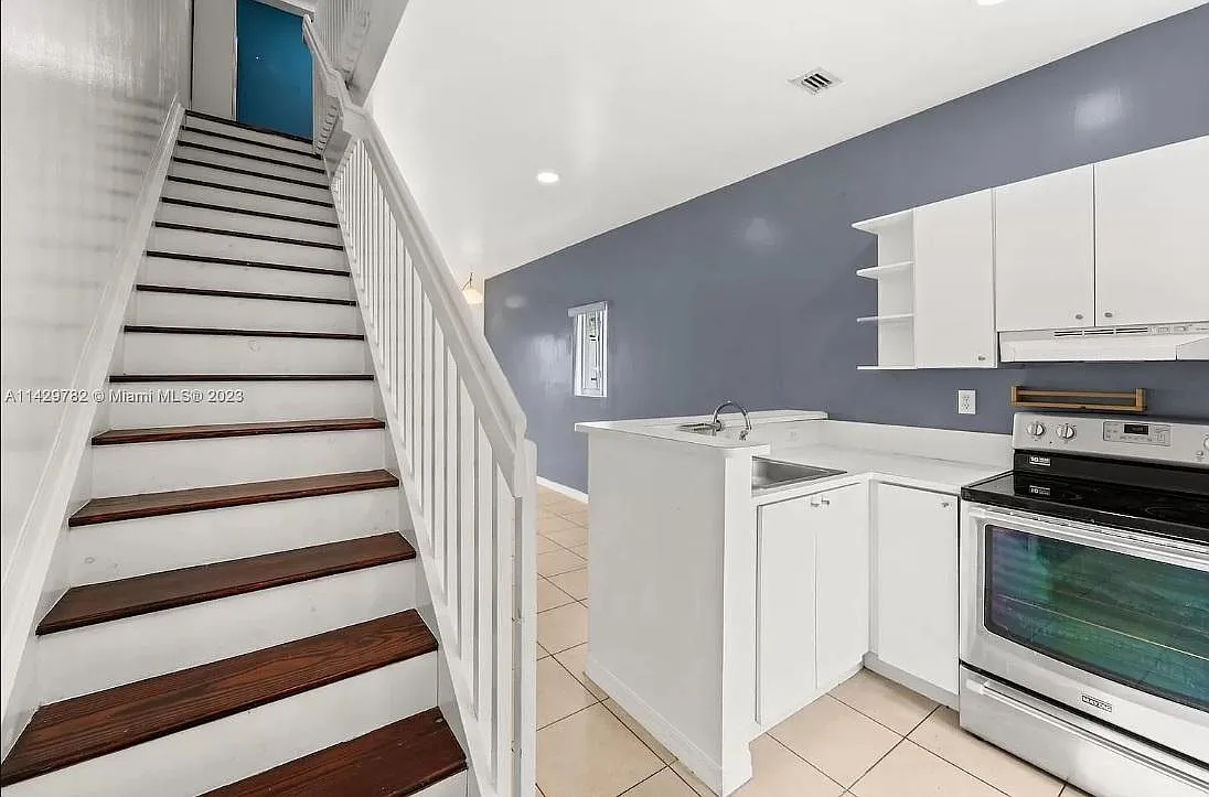 Photo 1 of 16 - 928 SW 3rd St #210 - Miami, FL Entrance: Features a view of the stairs and kitchen to the right, with impressive high ceilings. - 928 SW 3rd St #210