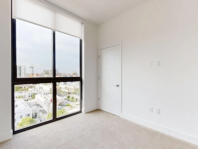 Spacious apartment Bedroom with carpet floors.