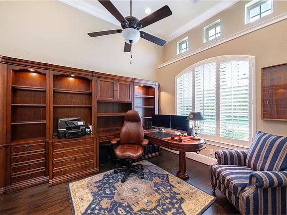 Spacious study hosts beautiful wood floors, high ceilings and a view of the lake. Makes working from home easy!