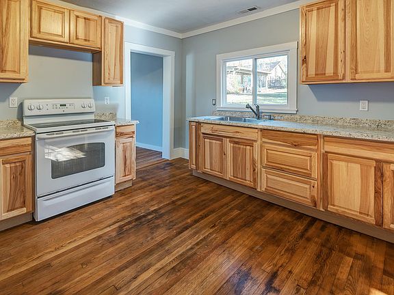 Kitchen and door to larger bedroom.