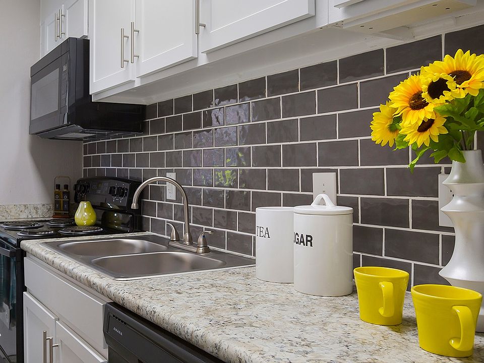 Model kitchen with granite-style counters and white cabinets