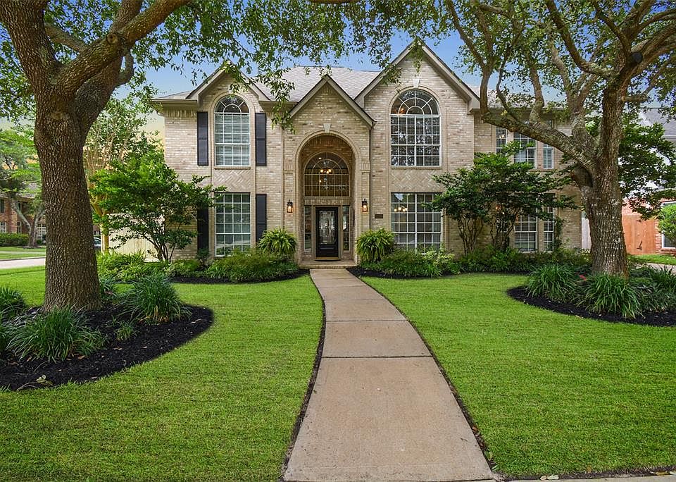 This 2 story stunning home beckons visitors! The home is set within mature trees and lush planting beds, a manicured lawn, freshly laid mulch and on a corner lot.