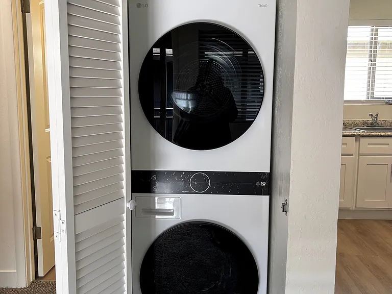 Convenient in-unit laundry with a modern stackable washer and dryer.