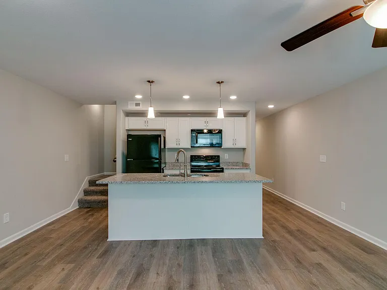 View of Kitchen. Hallway Entrance on right and Stairway to bedrooms on left