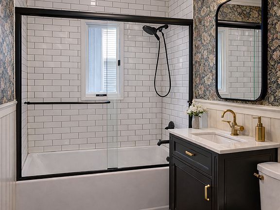 Fully renovated bathroom with a shower niche and natural light.