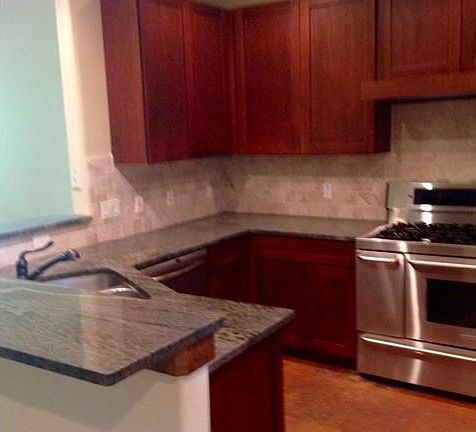 Kitchen opens to living. Granite