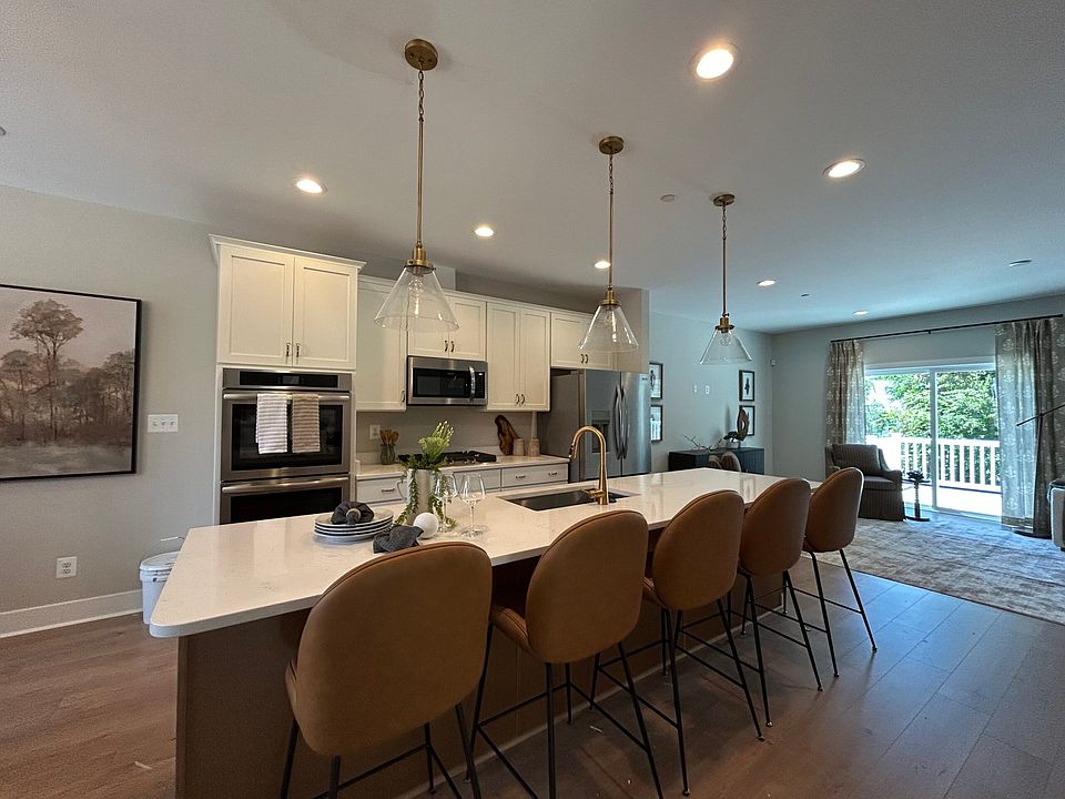 Open-concept kitchen in The Parkland townhome at Bell s Tower in Bel Air, featuring an oversized cen