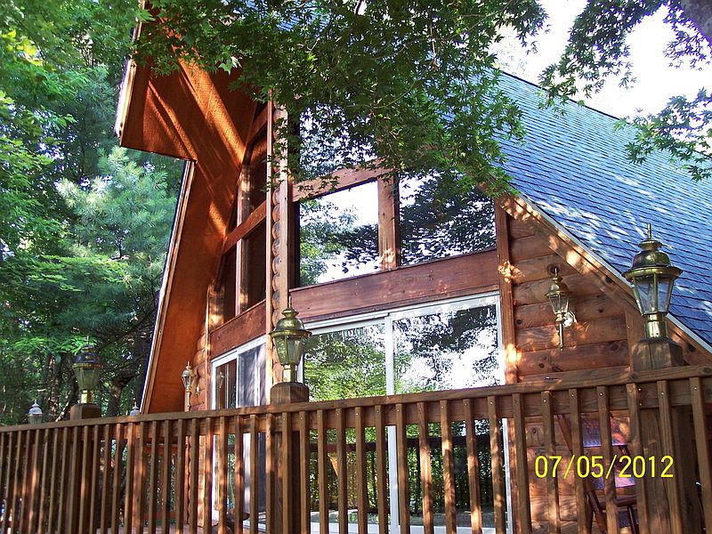 great room from backyard
						:
						partial view of 500 sq ft deck from back yard,side of house with wood
