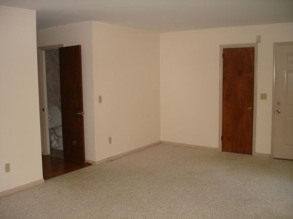 Living Room showing Hall 1/2 bath and Front door