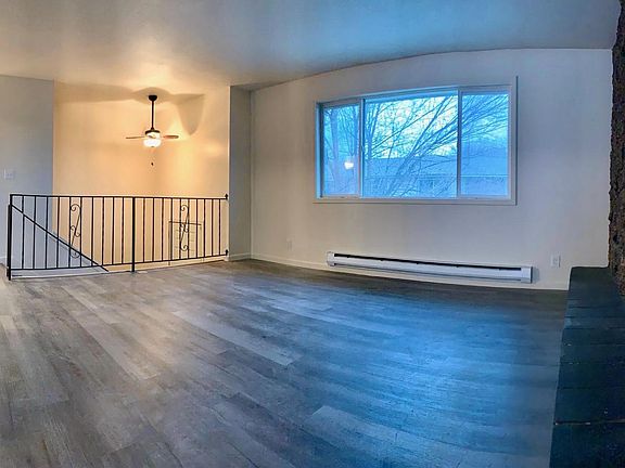 Spacious upstairs living room which boasts natural light. Complete with a fireplace. Home also has a downstairs living room with a fireplace and large window.