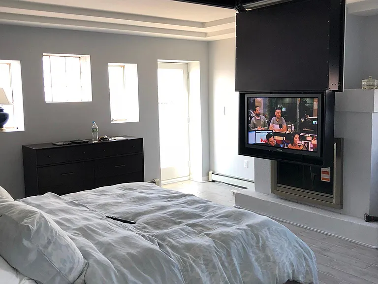 Master bedroom with flat screen tv ceiling mounted