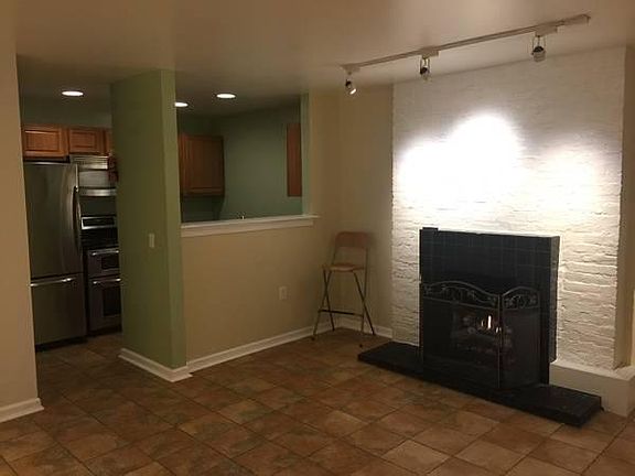 Fireplace and view of kitchen