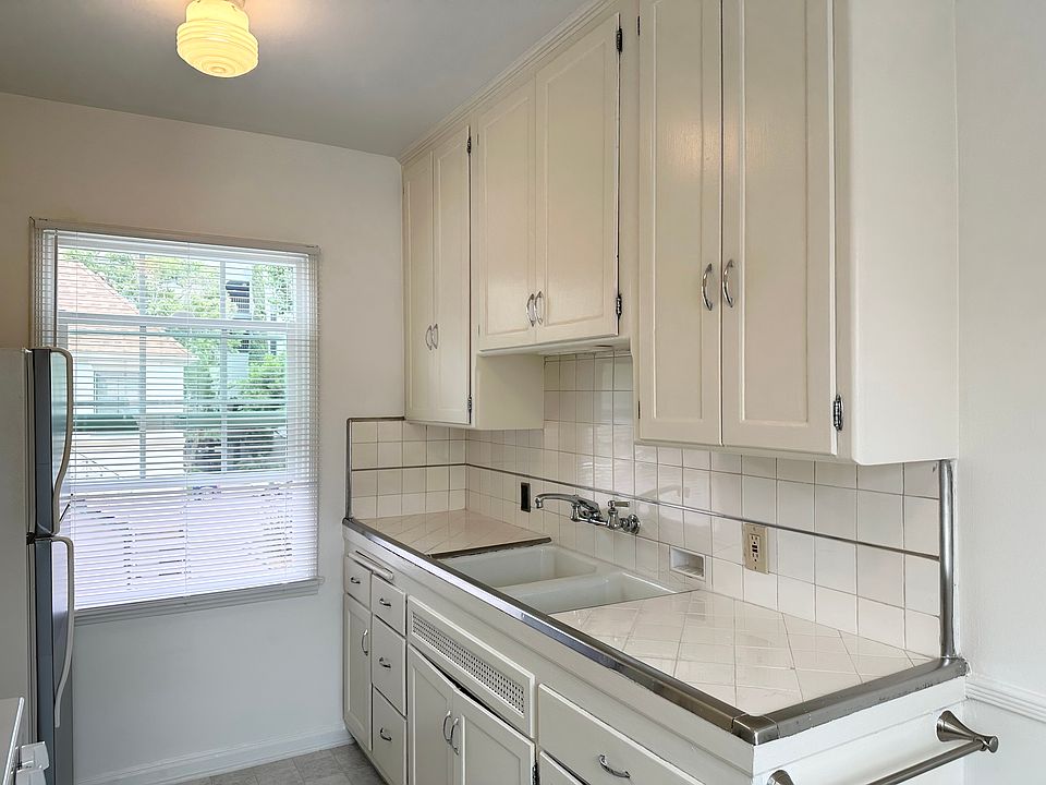 Kitchen with a large window and new blinds