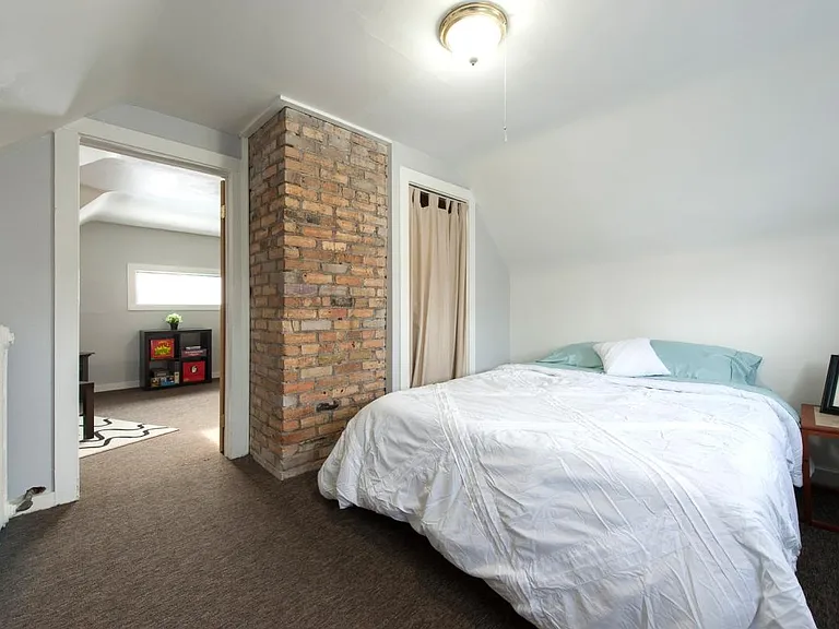 Second floor bedroom with exposed brick