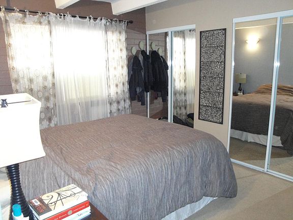 Two large closets in primary bedroom. Walls have been painted blue and white.