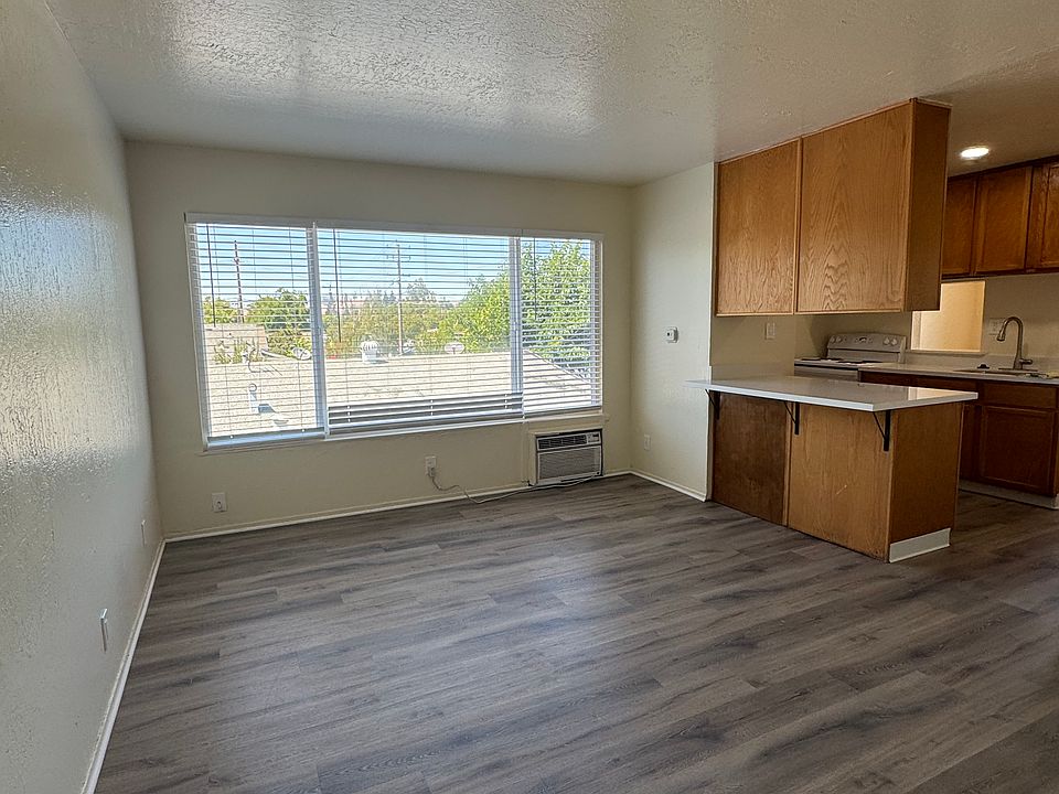 Front living room includes air condition wall unit. Large window allows for plenty of bright, natural light.