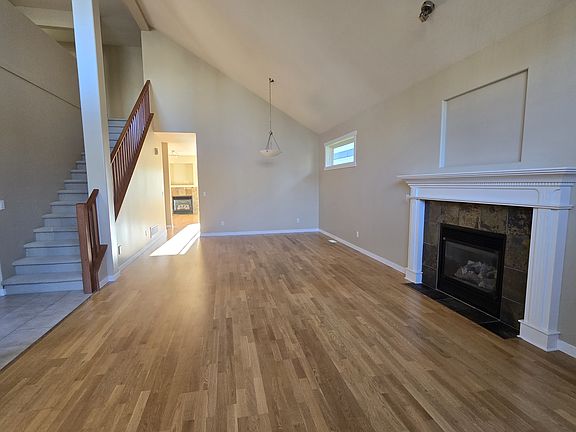 Open concept living/dining room with gas fireplace and 20 foot ceilings
