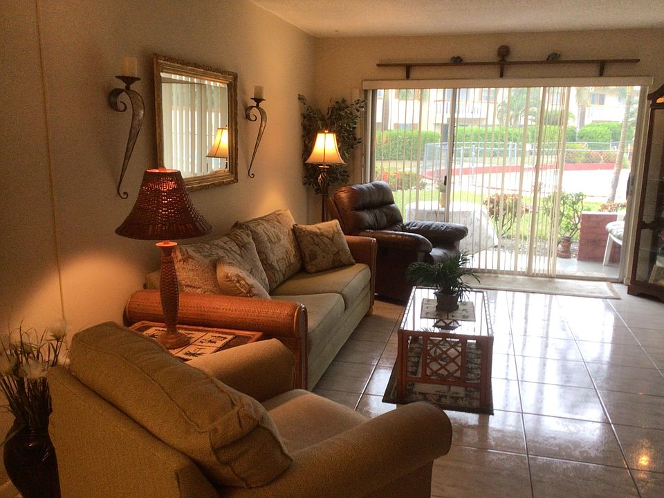 Living room includes all furniture with pull out Florida style couch and slider door to pool area.