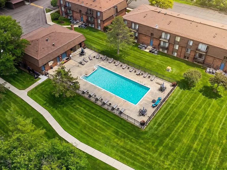 Expansive green space and heated pool at Drawbridge Apartments in Harrison Township, MI.