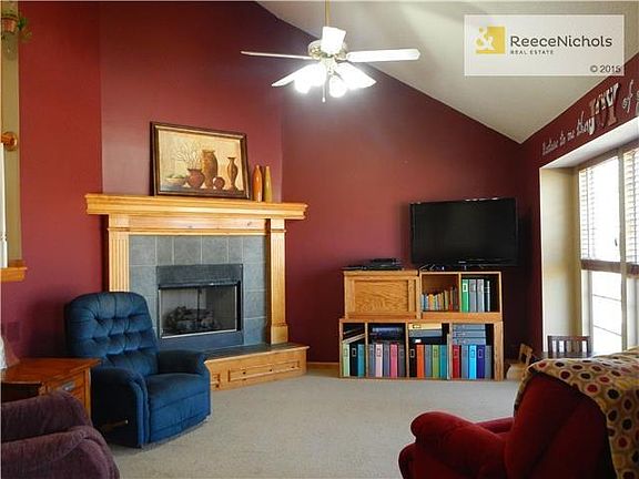 Welcoming Soaring Ceilings in Roomy Great Room with attractive fireplace.