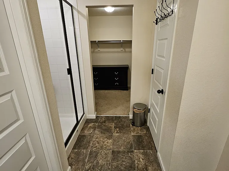 Master bath leading into walk-in closet.