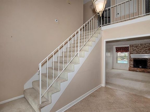 As you enter the home you are welcomed with a grand, two-story entryway.