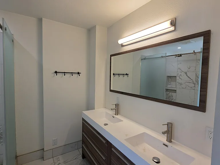 Primary bath with two sinks and shower.