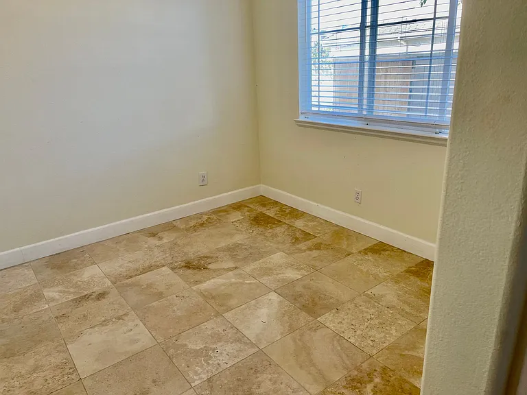 Bedroom with Travertine flooring