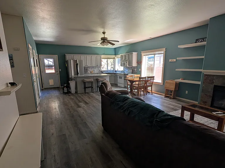Open-plan layout of living room, dining area, and kitchen