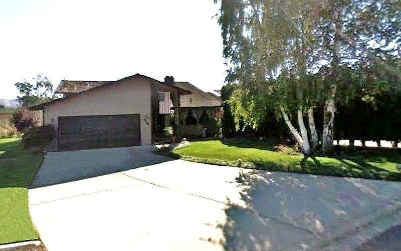 Front of house showing two-car garage and long, wide driveway