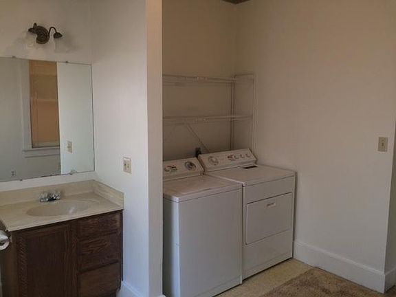 Laundry room has 1/2 bath with sink and toilet.