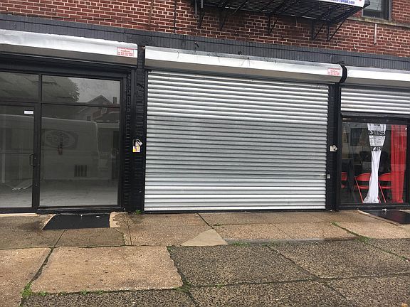 Front View Displaying 2 Additional Store Fronts Next Door