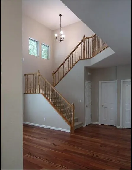 stairs, door to coat closet under the stairs, door to half bathroom, door to laundry/ garage