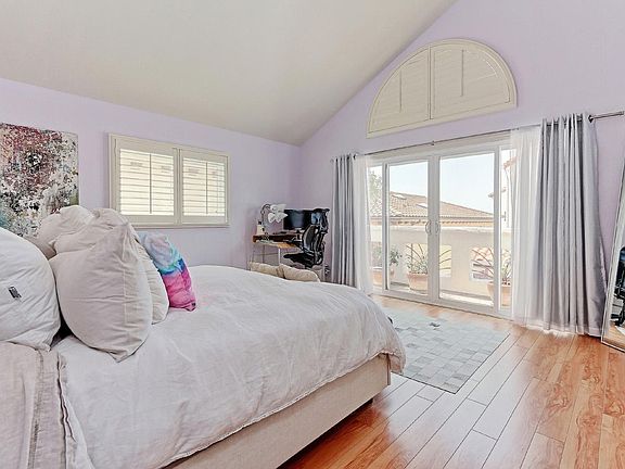 Spacious master bedroom with soaring ceilings and private de