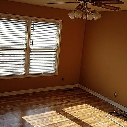 Living room with Ceiling fan, central air, programmed a/c