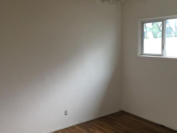 Bedroom two with ceiling fan and lots of cabinets
