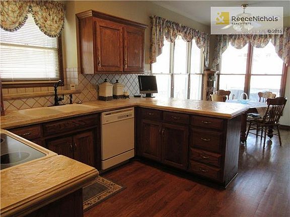 Kitchen looking across breakfast bar to eating area.  Wood Floors.