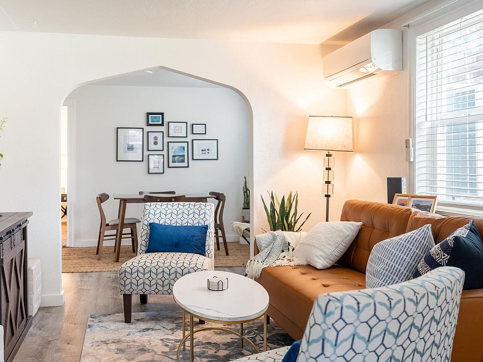Living room with 50in TV, storage cabinet and mini-split a/c & heat unit