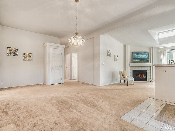 Open floor plan highlighting the dining area and gas fireplace in the living room 