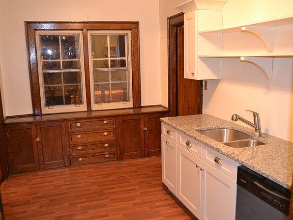 Butler's pantry with original built-in tiger-stripe maple ca