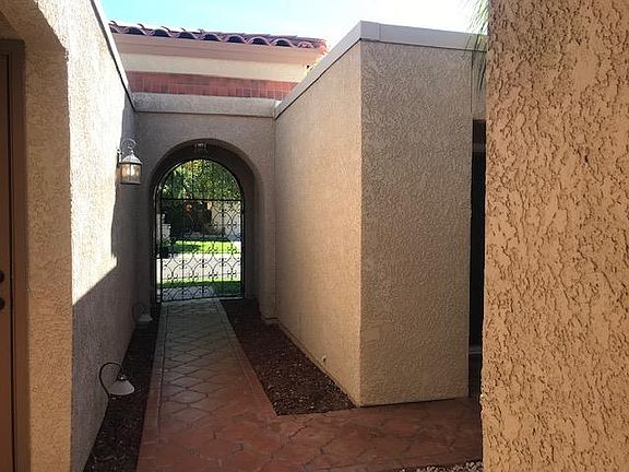 Looking back to the street from the front door. There is a garage entry on the left and a slider to the casita in the opening to the right
