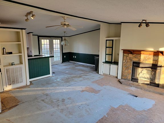 Open floor plan with Large living room with a beautiful rock Fireplace, dining room, and Kitchen.