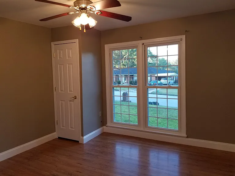 Bedroom one before new flooring and paint