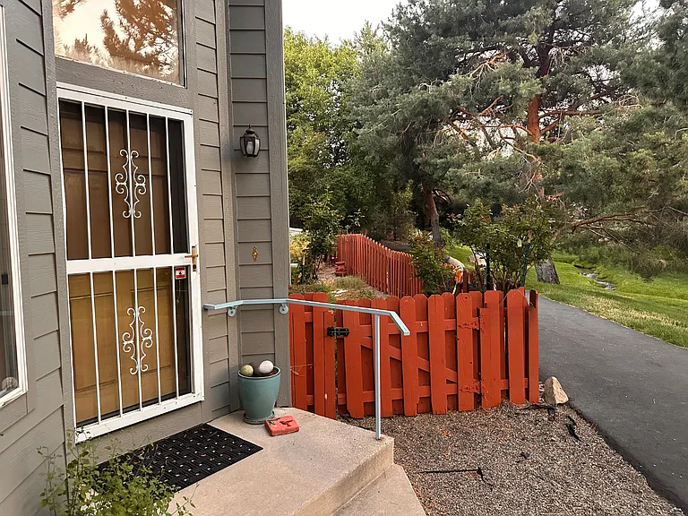 Front door and a gate into the side and the backyard.