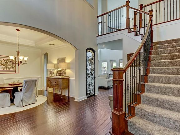 Arched openings, high ceilings and wood floors showcase this beautiful entry.