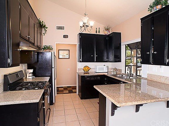 The lovely kitchen with granite counter tops, rich
