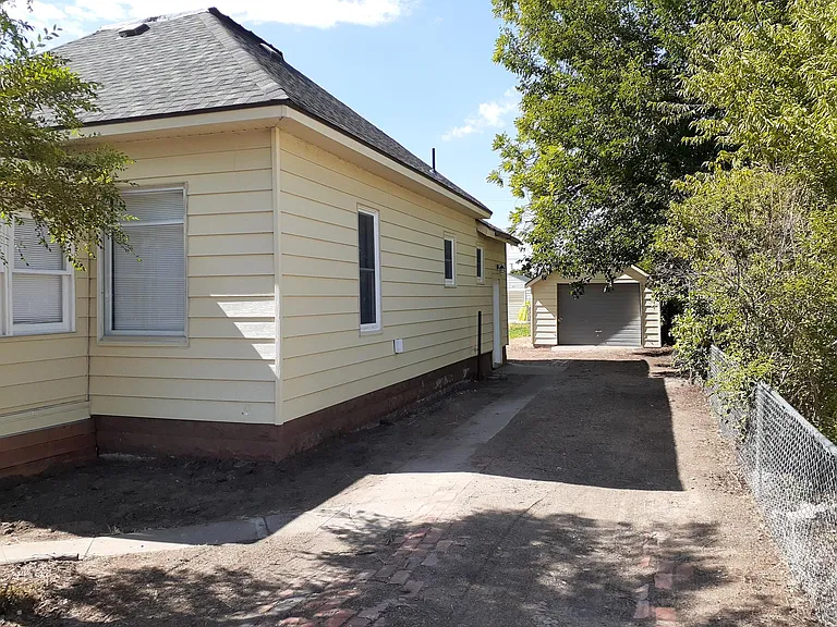 Large yard with a sizable driveway.