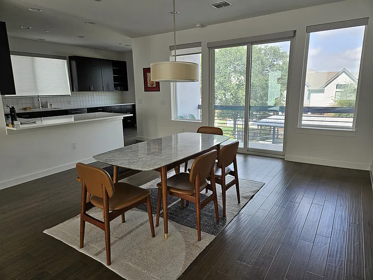 Dining area looking into kitchen and outdoor patio